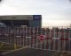 The big red and white striped barriers across the taxi-way open; Copyright Peter Sheil 2003